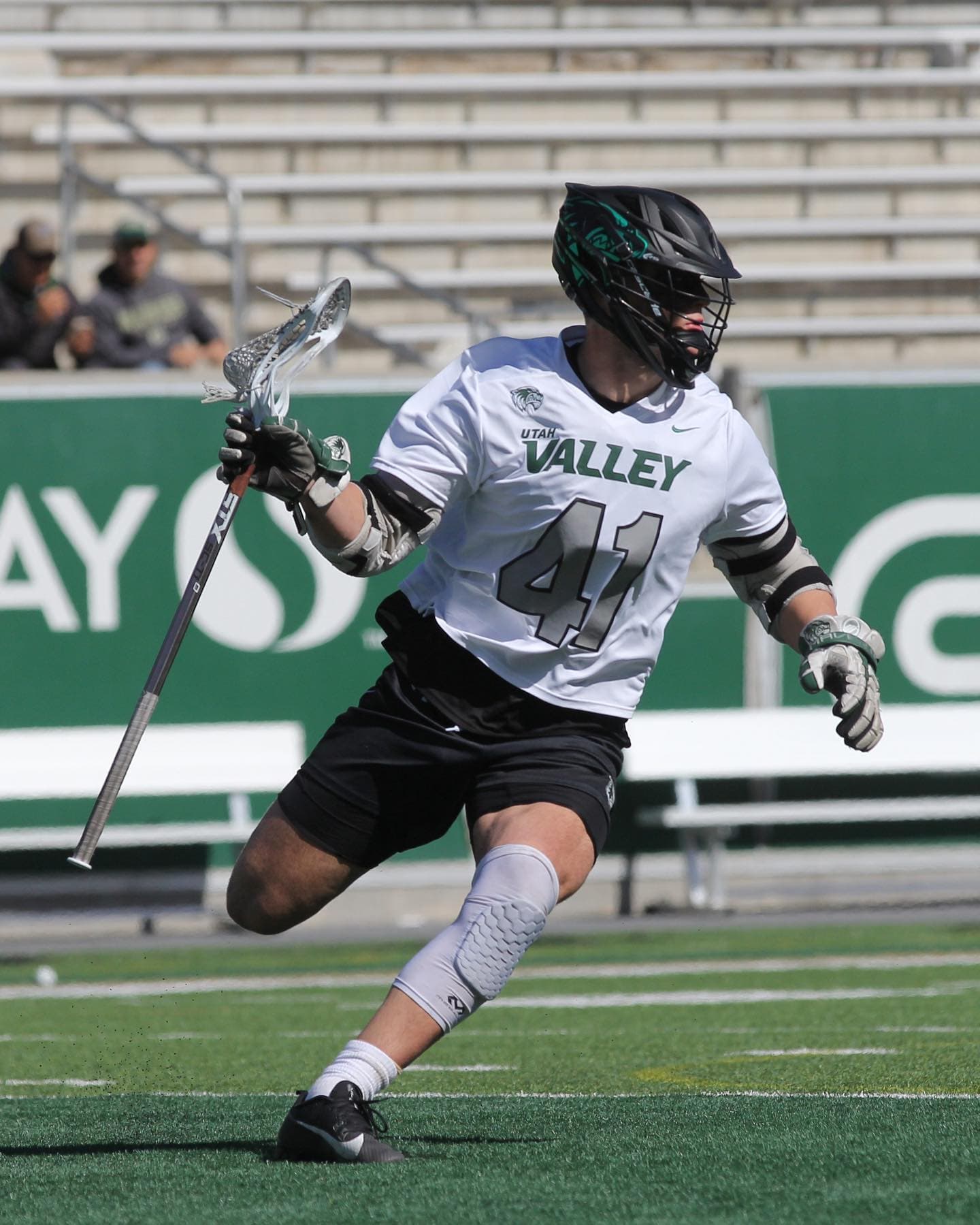 Jake Lundin carrying the ball during a Utah Valley lacrosse game.